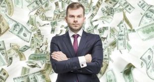 serious businessman standing with money falling background 573x300
