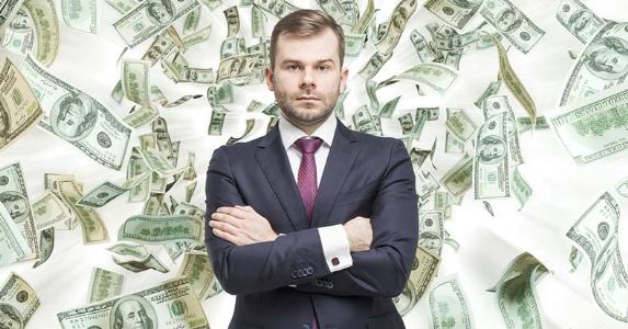 serious businessman standing with money falling